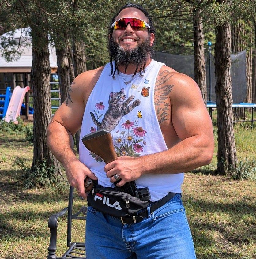Matt Weiss outdoors, smiling in sunglasses and a cat-print shirt